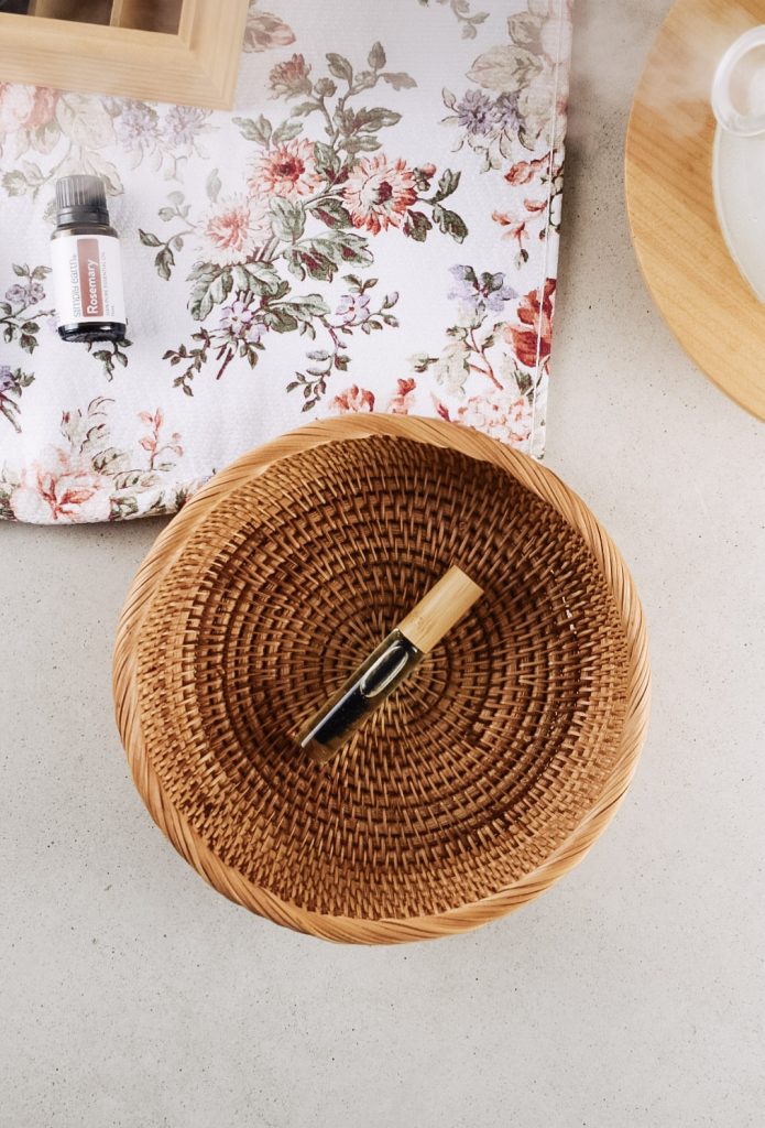 DIY lash growth serum in a rattan basket on the kitchen counter.