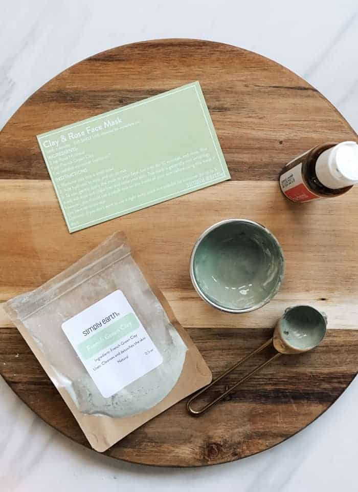 Items from essential oil subscription box lying on wooden cutting board