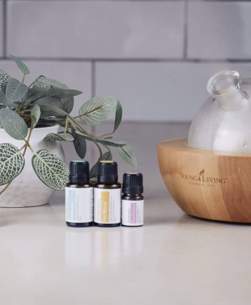 Simply Earth essential oils next to an essential oil diffuser on the kitchen counter.