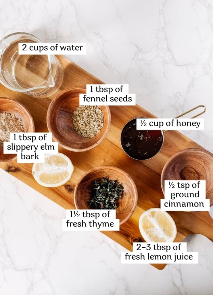 Ingredients to make homemade cough syrup on a wooden cutting board.