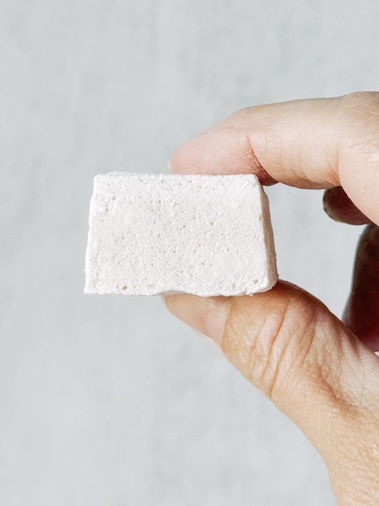 A person holding a homemade marshmallow.